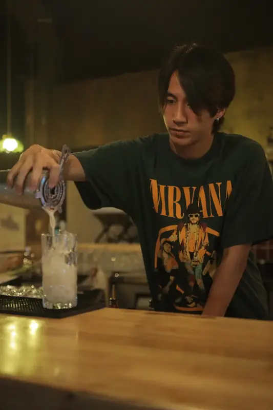 Our bartender pouring a cocktail at the bar
